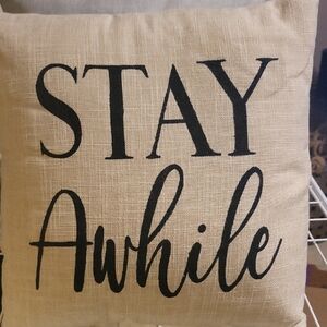 Decorative Tan Pillow with Black Text